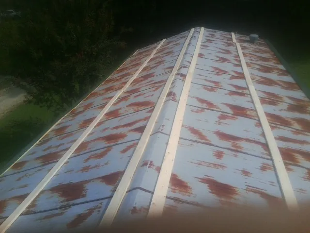 Rusted metal roof panels with new wood purlins before replacement — Storm Damage Roof Repair in Landrum by Roofing Brothers