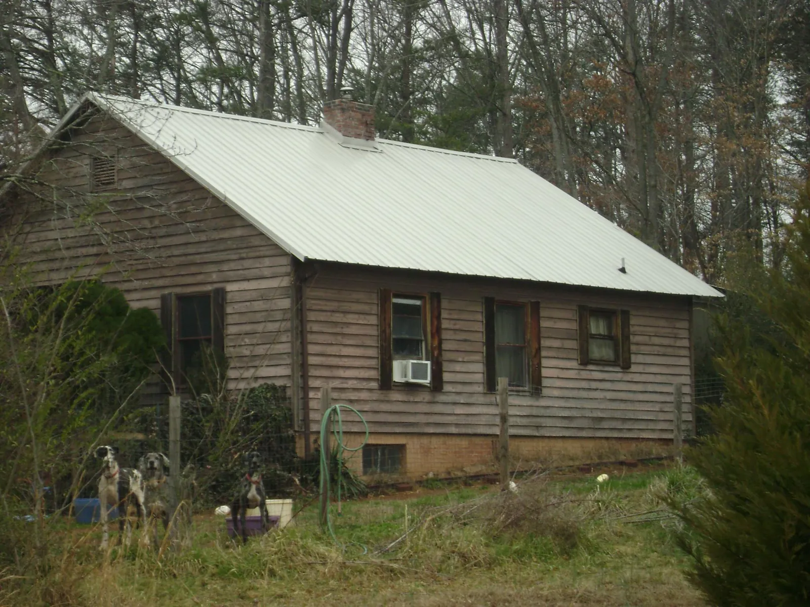 White metal roof on an old wood sided farmhouse, from a Metal Roof Installation job in Landrum